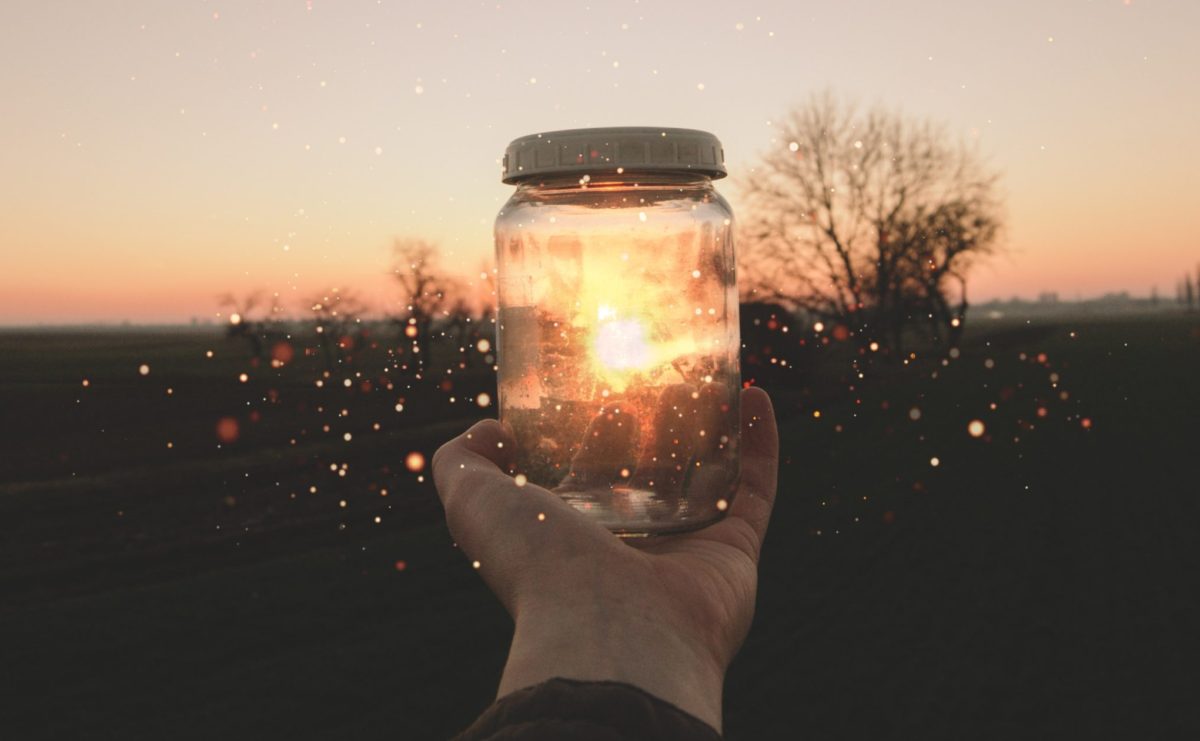 person holding glass jar