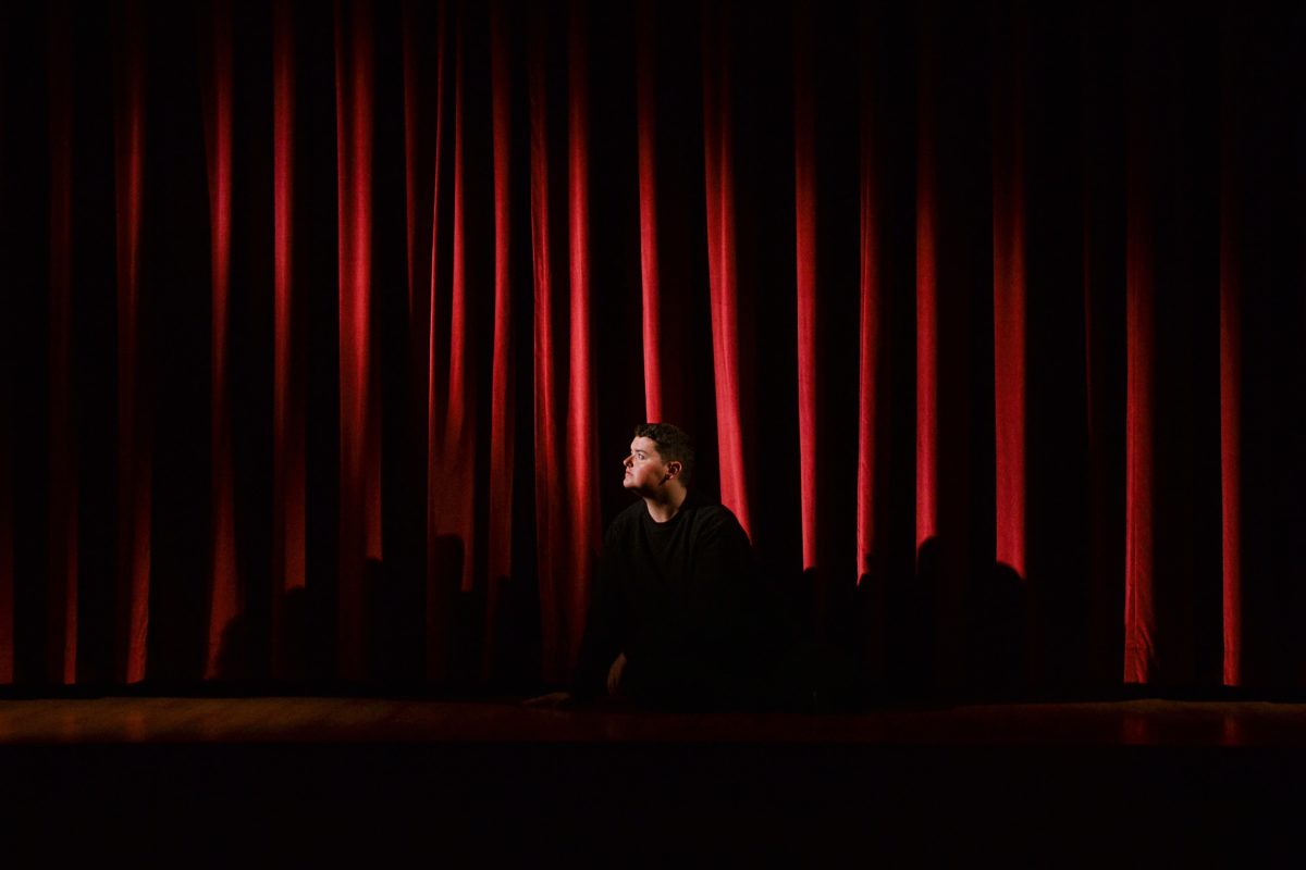 Man on stage in a theater.