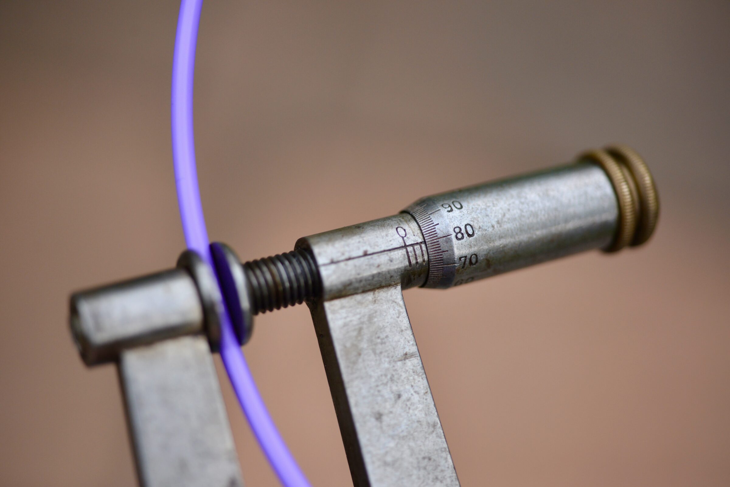 Using an engineer's micrometer to measure 3D printing filament.