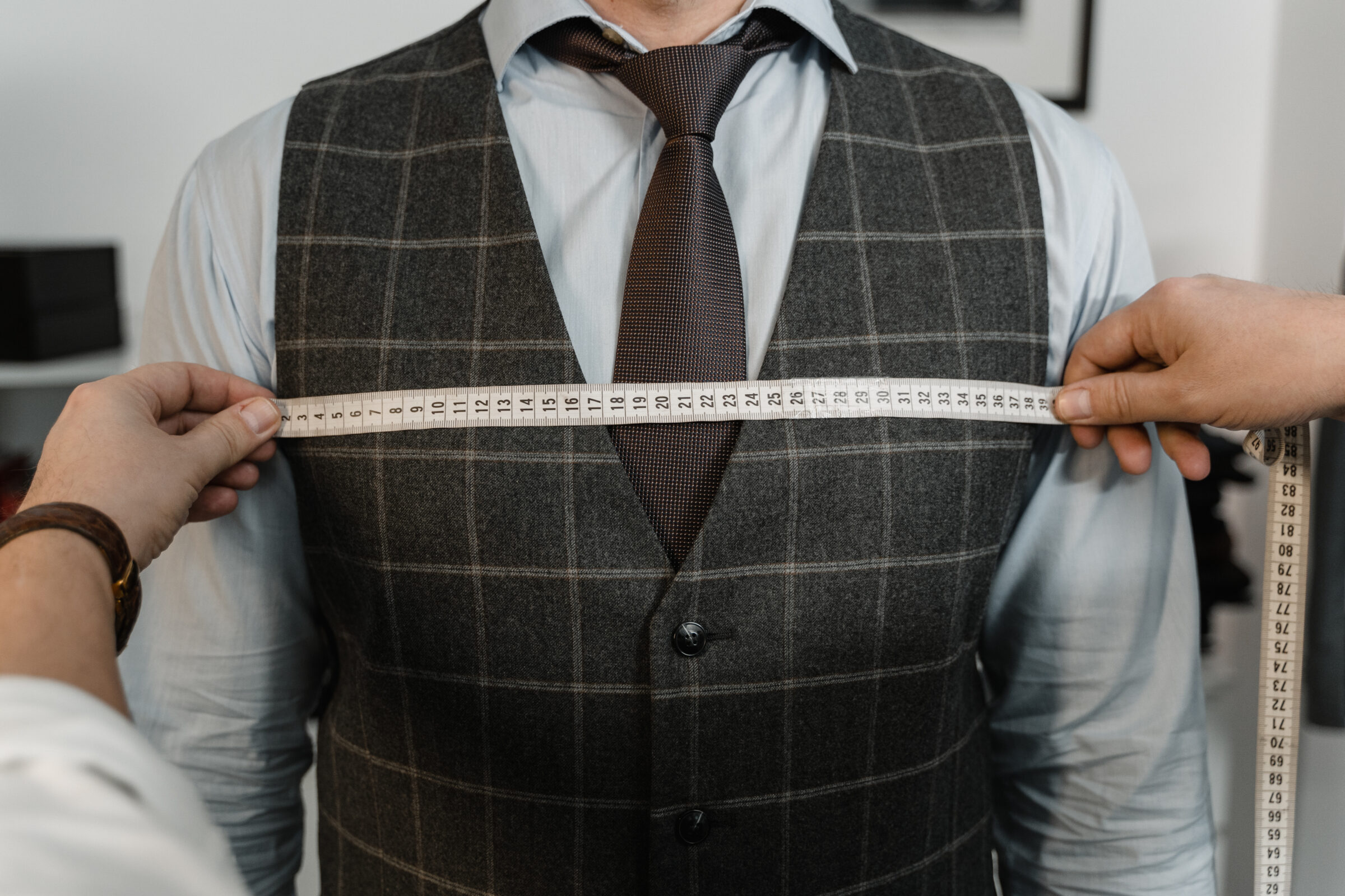 Tailor measuring a client s chest